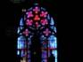 Stained glass window and chandelier in St. Stephens Cathedral in Vienna, Austria