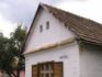 A traditional Slovak village home with a picture frame style of window shutter